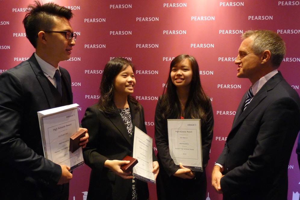 Mr Steven McGill, Head of Pearson’s Asia Partner Markets, chats with 3 of the 5 High Achiever Award winners from HELP Academy and congratulates Melissa Chee (center) on having gained admission to Cambridge.