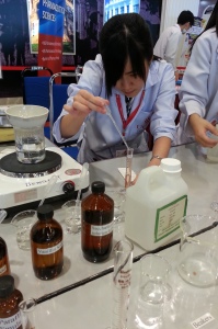 A UCSI University Pharmacy student giving a public demonstration about making medicines